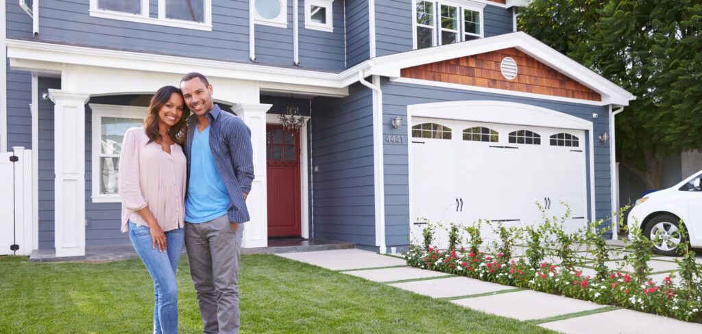 Proud homeowners standing outside